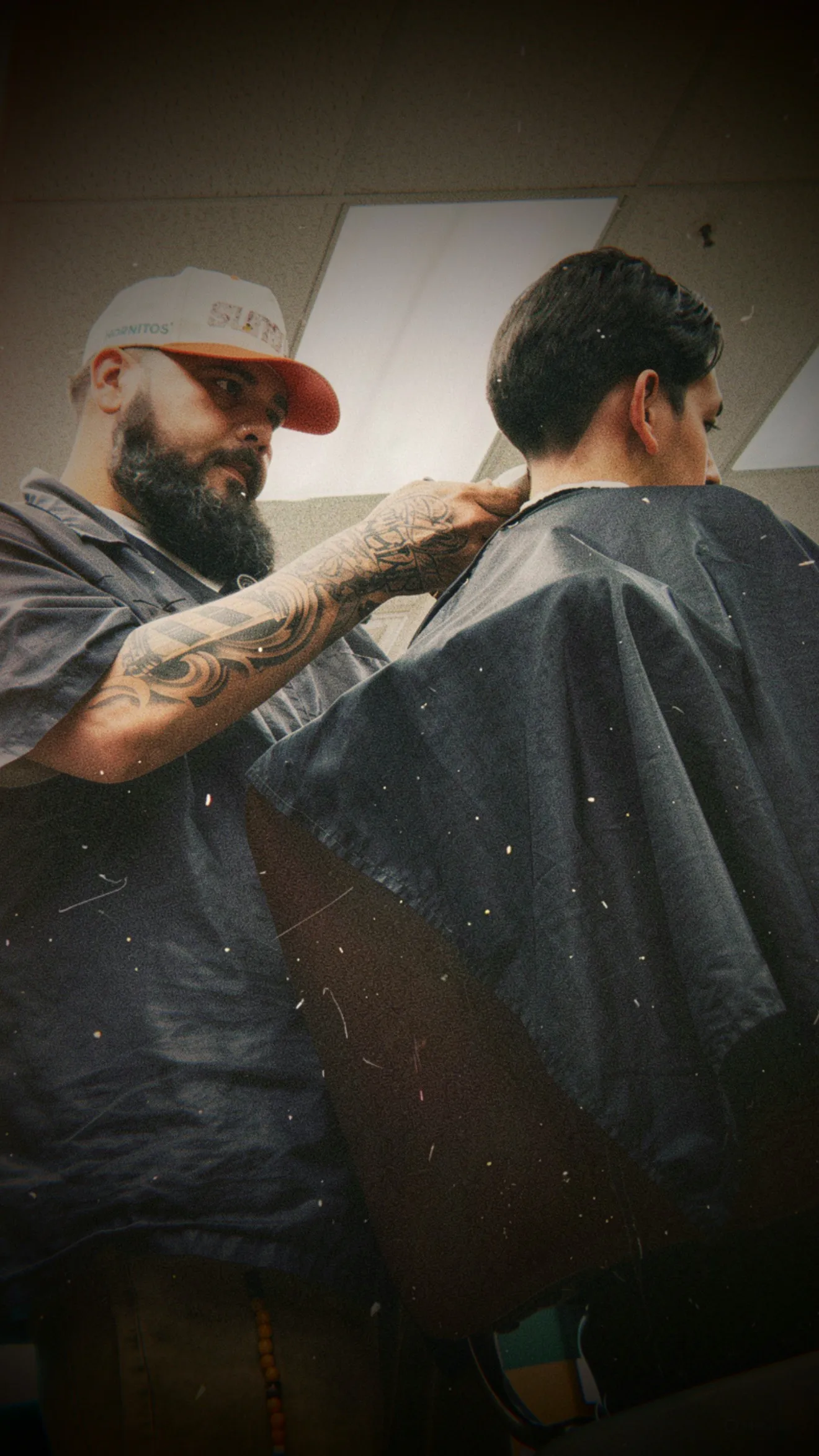 Mando cutting a client's hair at the barbershop